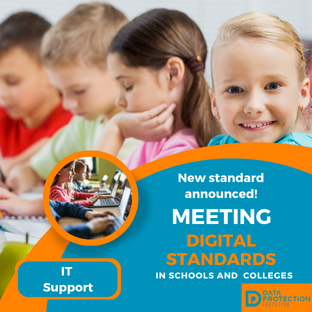  A promotional image for new digital standards in education.  The top half shows four primary school-age children sitting at a desk, looking down and focusing on work. The child closest to the camera on the right is smiling.  The bottom half has an orange and blue graphic overlay that reads: "New standard announced! MEETING DIGITAL STANDARDS IN SCHOOLS AND COLLEGES." In the bottom left corner is a circle image showing students working on laptops. The text "IT Support" is written in a yellow box below the circle. In the bottom right corner is a logo for the "DATA PROTECTION EDUCATION" initiative.